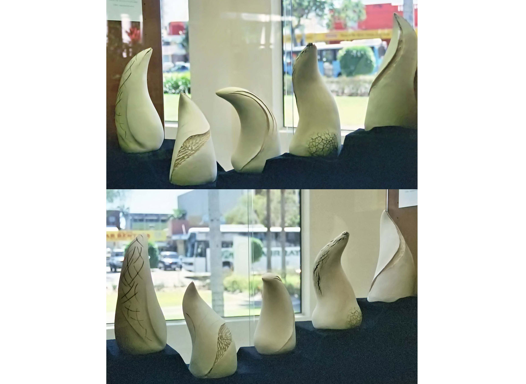 Five sculptures, each representing crocodile teeth, each with marks of nature on them in the Cairns City Library